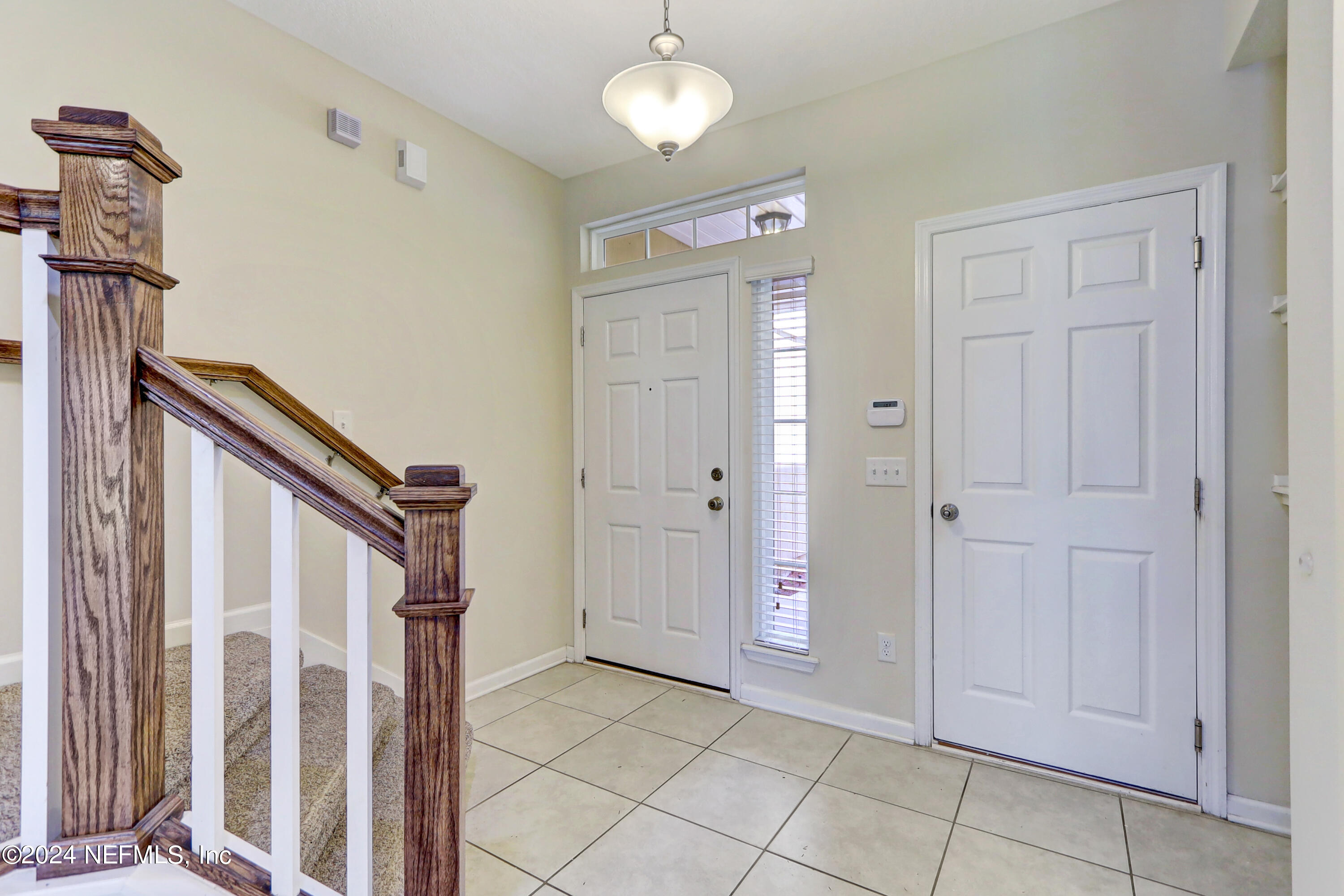 95 Nelson Lane St. Johns, FL 32259 - Photo 4 of 30 a view of a hallway with entryway and chandelier