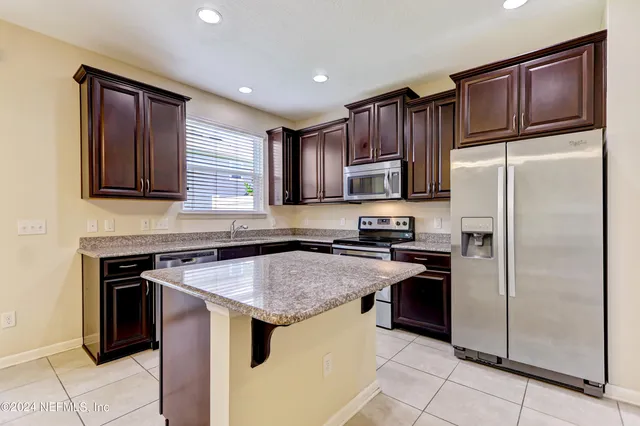 a kitchen with a refrigerator sink and microwave
