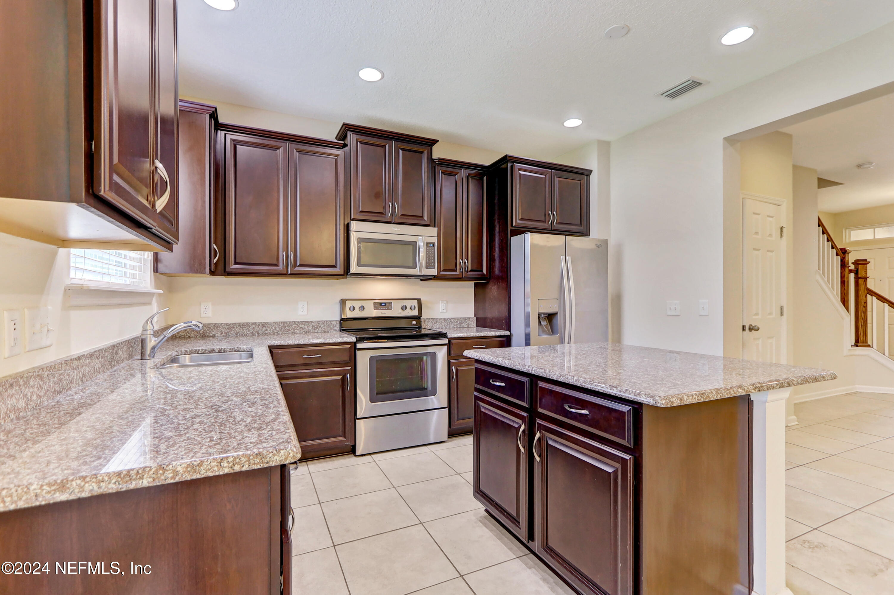 95 Nelson Lane St. Johns, FL 32259 - Photo 9 of 30 a kitchen with stainless steel appliances granite countertop a refrigerator stove microwave and sink