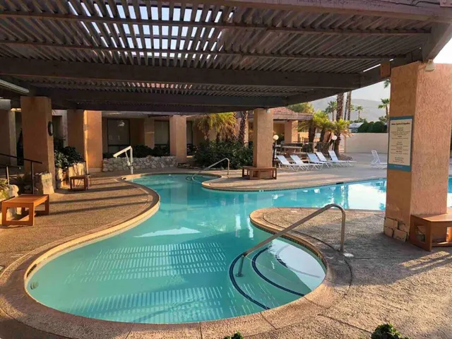 a view of a swimming pool with seating space