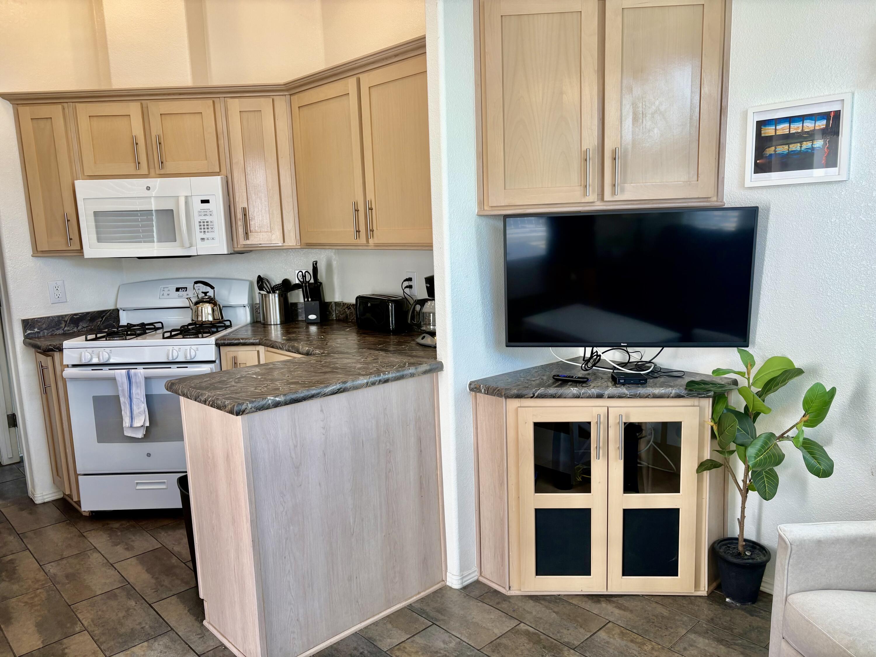 74711 Dillon Road, Unit 247 Desert Hot Springs, CA 92241 - Photo 7 of 33 a view of kitchen with microwave stove refrigerator and cabinets