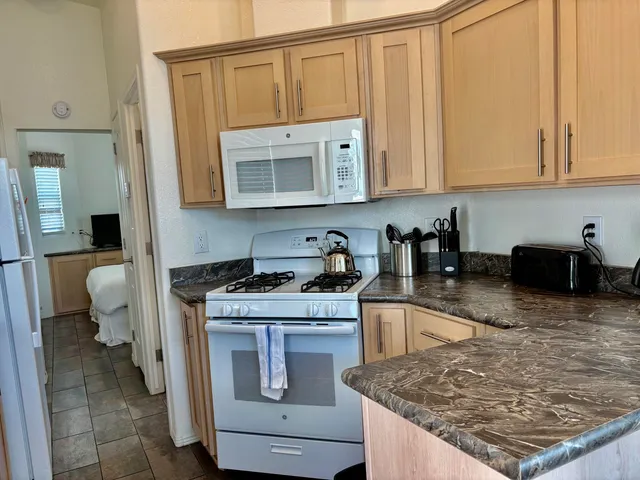 a kitchen with stainless steel appliances granite countertop a sink stove and cabinets