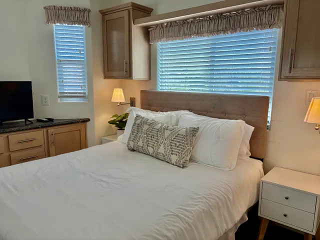 a bedroom with a bed and a window