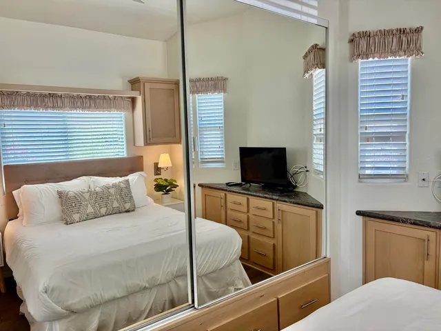 a bedroom with a bed and a television