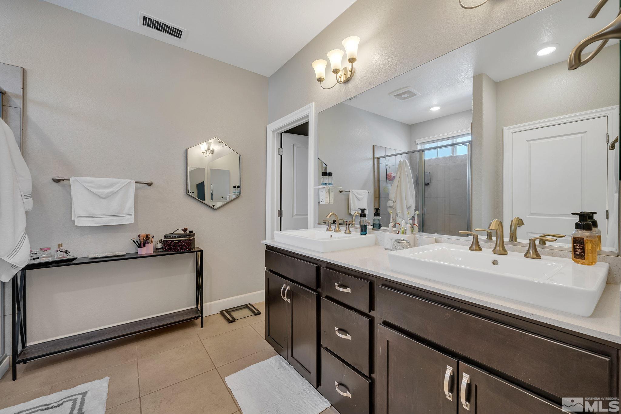 1914 Sea Horse Road, Unit A Reno, NV 89521 - Photo 17 of 28 a bathroom with a sink double vanity and a mirror