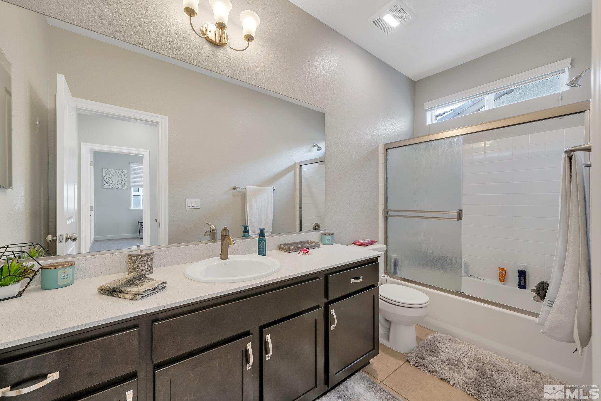 1914 Sea Horse Road, Unit A Reno, NV 89521 - Photo 21 of 28 a bathroom with a double vanity sink toilet and shower