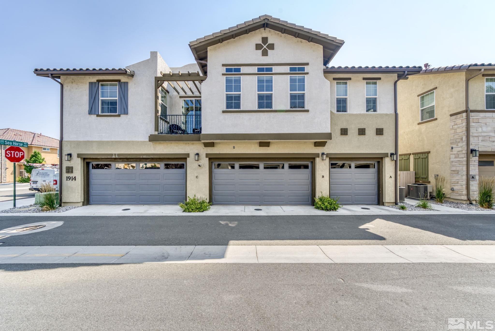 1914 Sea Horse Road, Unit A Reno, NV 89521 - Photo 27 of 28 a front view of a house with a road and a garage
