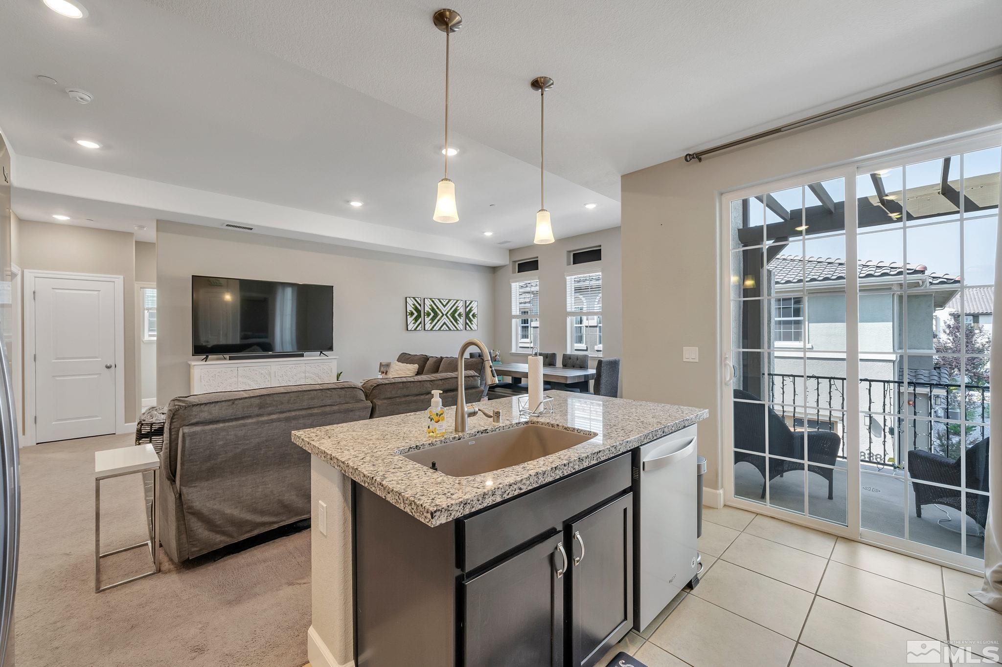 1914 Sea Horse Road, Unit A Reno, NV 89521 - Photo 7 of 28 a kitchen with granite countertop a sink and a stove