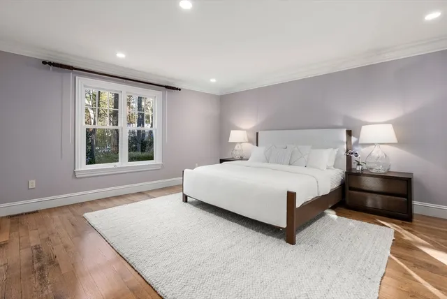 a bedroom with a large bed and a large window