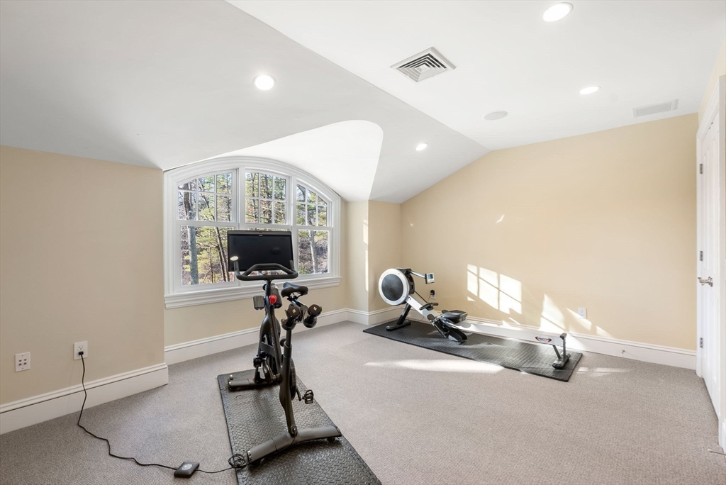 182 Winding River Road Wellesley, MA 02482 - Photo 31 of 40 a room with gym equipment and a mirror