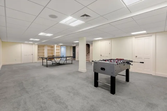 a living room with furniture pool table and a fireplace