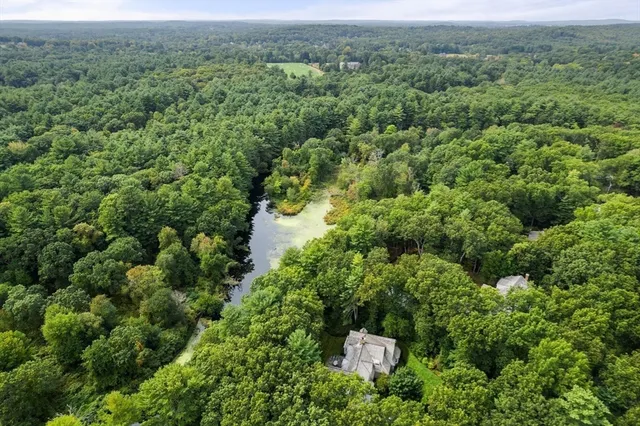 an aerial view of a house with a yard