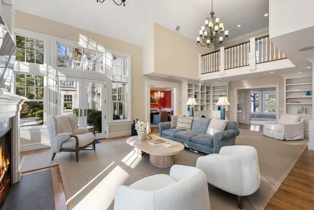 a living room with furniture chandelier and fireplace