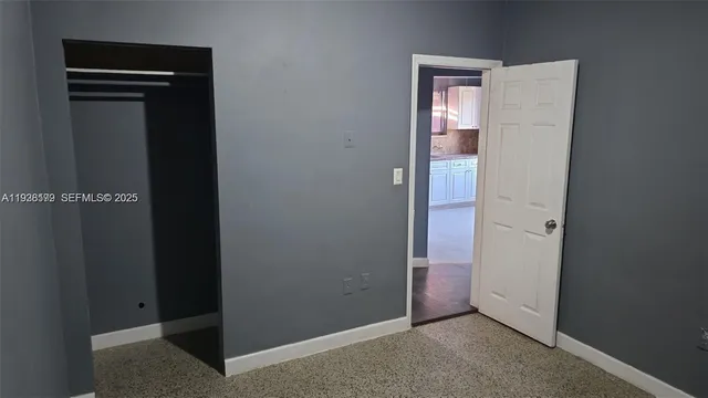 a white toilet sitting next to a shower