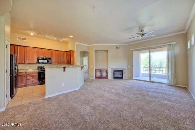 a view of a kitchen with a sink and a fireplace