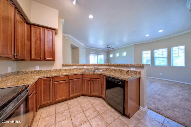 a kitchen with stainless steel appliances granite countertop a sink stove and cabinets