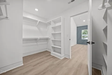 an empty room with windows and entrance