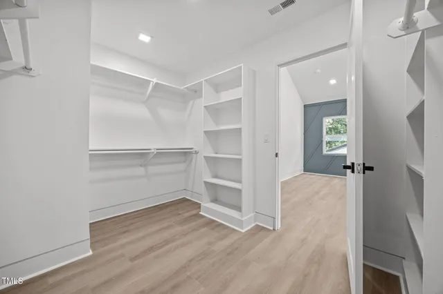 an empty room with windows and entrance