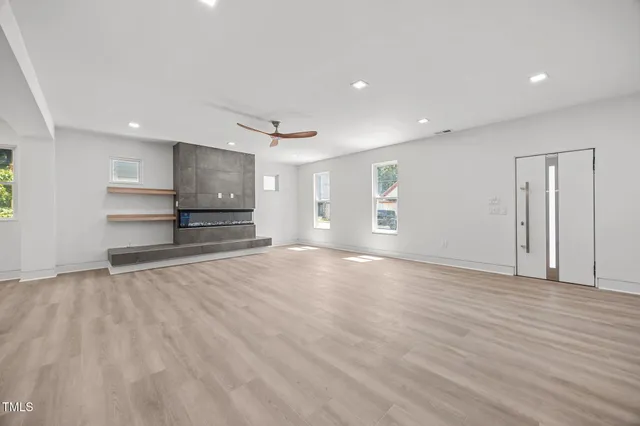 a view of empty room with wooden floor and window
