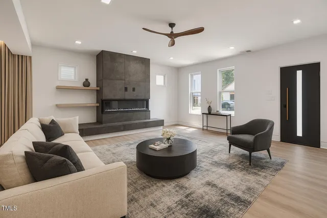 a living room with furniture and a wooden floor
