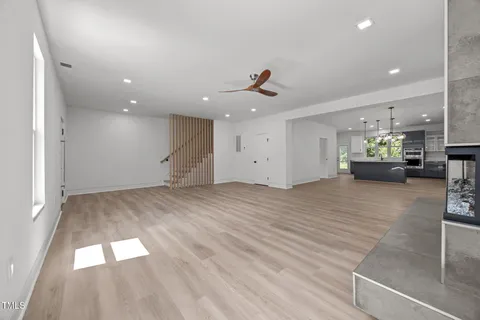 a large kitchen with kitchen island granite countertop a large counter top a sink stainless steel appliances and windows