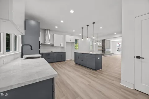 a large kitchen with kitchen island a large island in the center