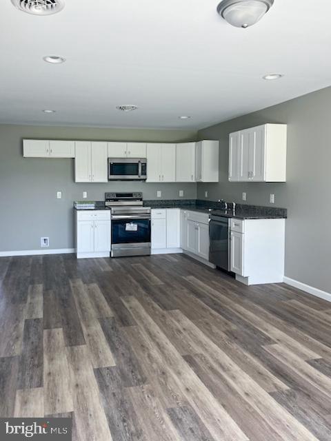 79 Pacific Avenue Milroy, PA 17063 - Photo 6 of 12 a kitchen with granite countertop a stove and cabinets