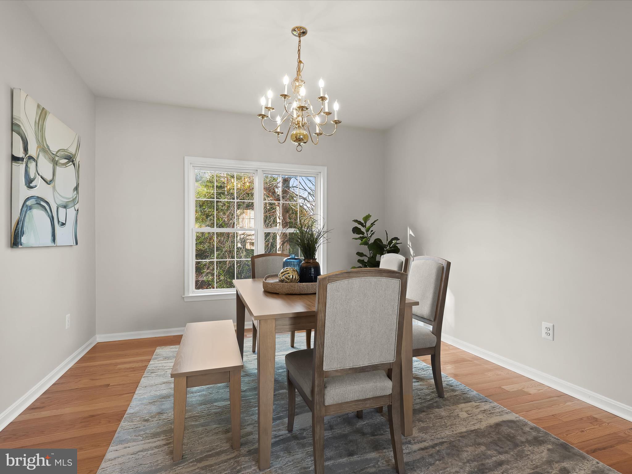 6413 Phantom Moon Walk Clarksville, MD 21029 - Photo 12 of 60 a dining room with furniture a chandelier and wooden floor