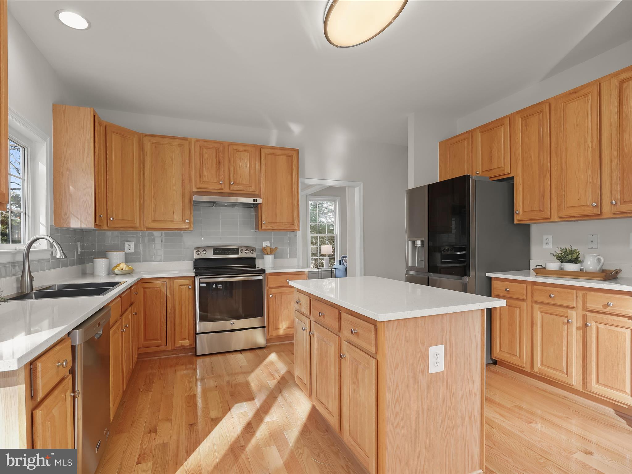 6413 Phantom Moon Walk Clarksville, MD 21029 - Photo 15 of 60 a kitchen with a stove a sink and a refrigerator