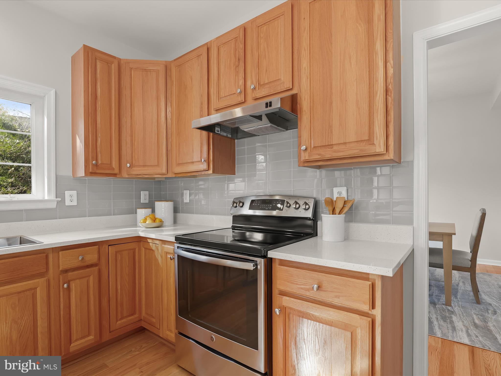 6413 Phantom Moon Walk Clarksville, MD 21029 - Photo 19 of 60 a kitchen with granite countertop a stove sink and cabinets