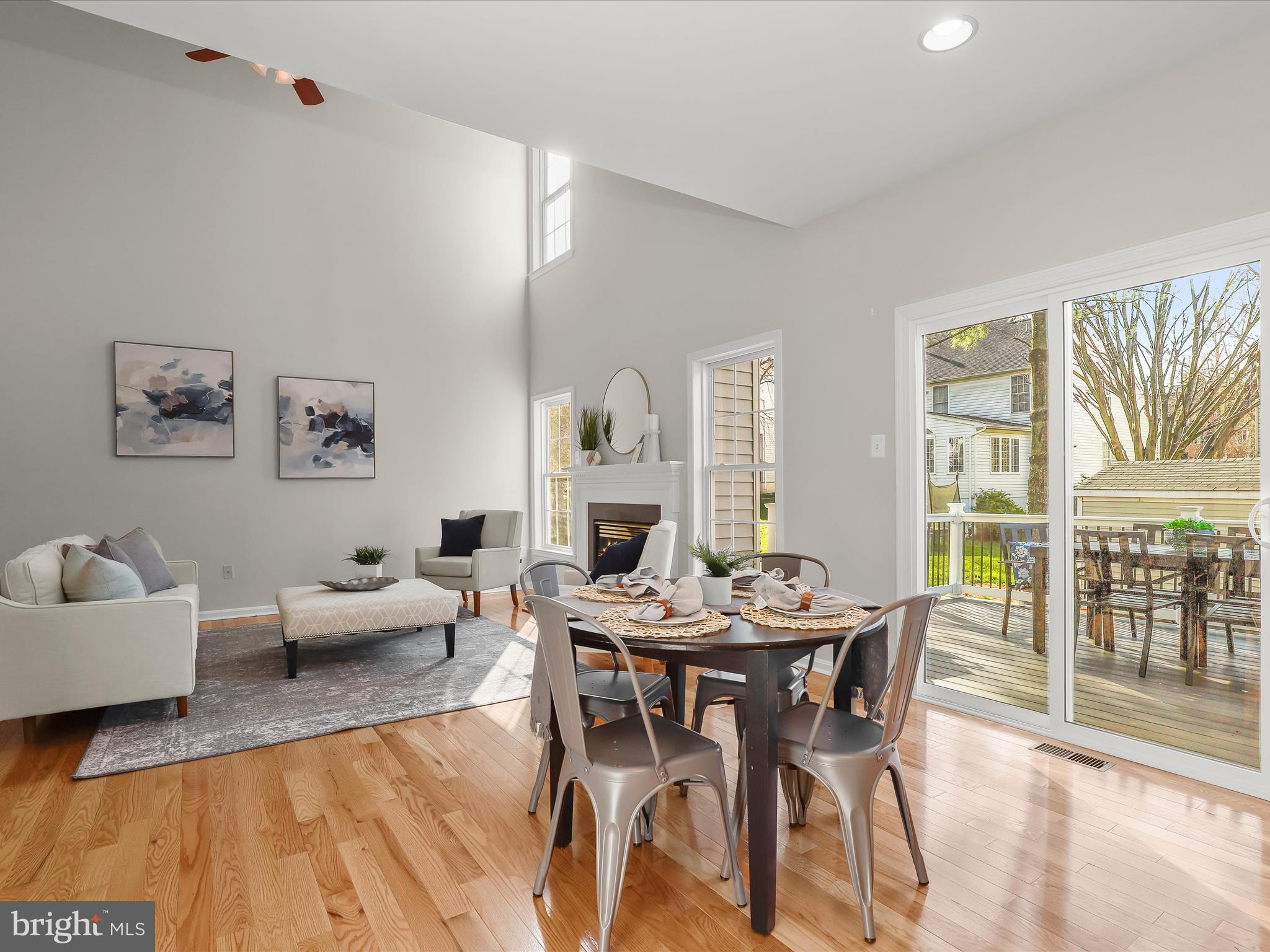 6413 Phantom Moon Walk Clarksville, MD 21029 - Photo 20 of 60 a view of a dining room with furniture large windows and wooden floor