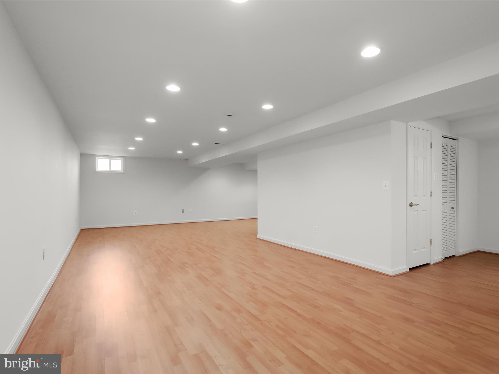 6413 Phantom Moon Walk Clarksville, MD 21029 - Photo 45 of 60 a view of an empty room with wooden floor and a window