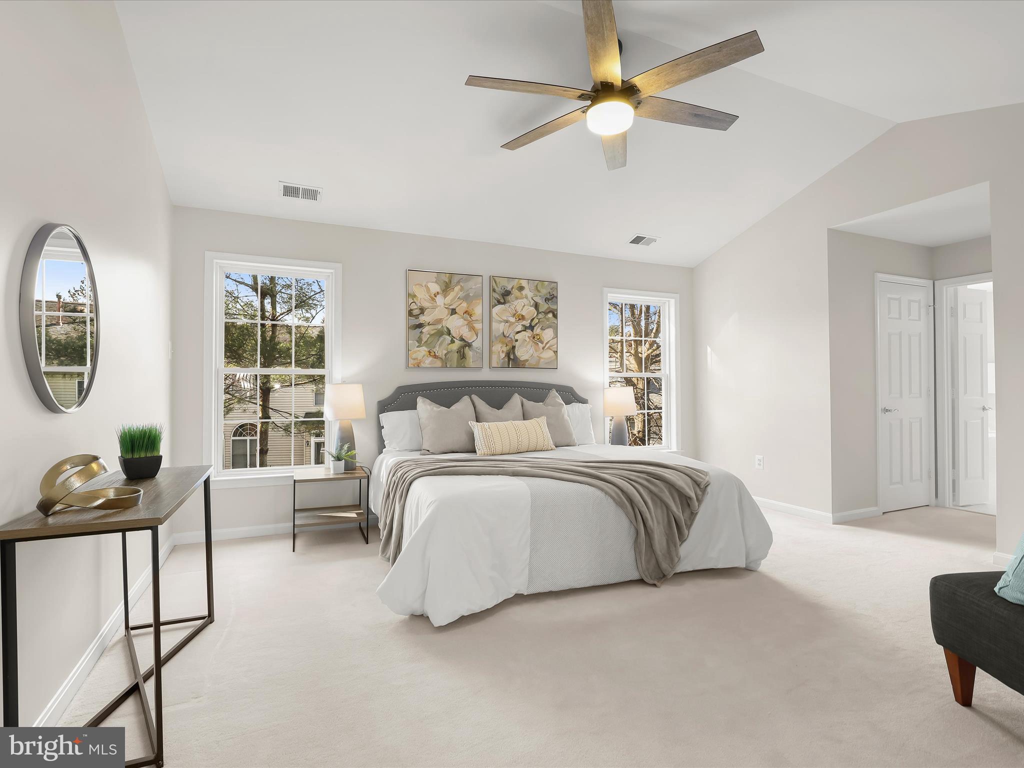 6413 Phantom Moon Walk Clarksville, MD 21029 - Photo 4 of 60 a spacious bedroom with a bed a couch and a chandelier