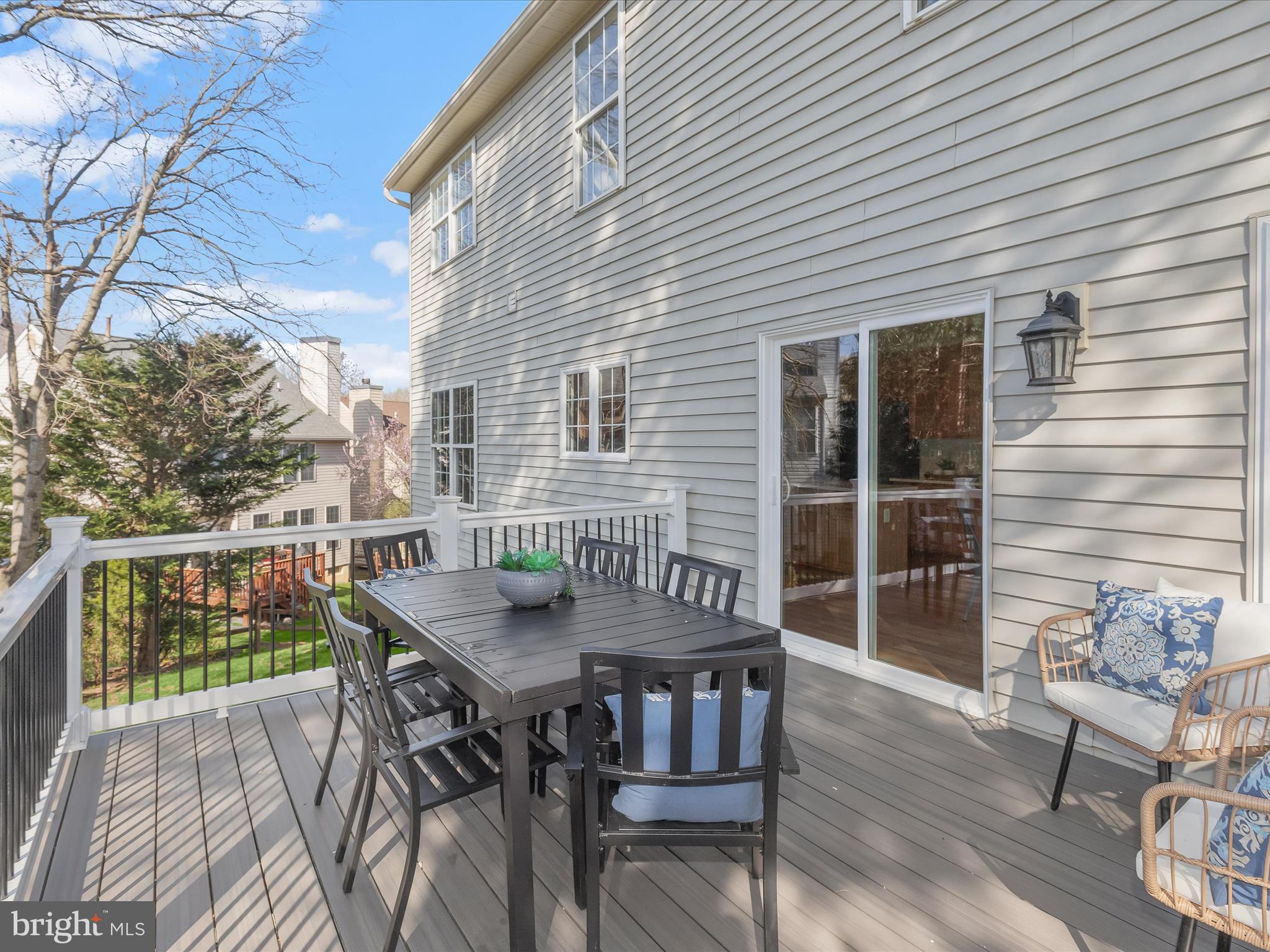 6413 Phantom Moon Walk Clarksville, MD 21029 - Photo 51 of 60 a view of a patio with table and chairs with wooden floor and fence