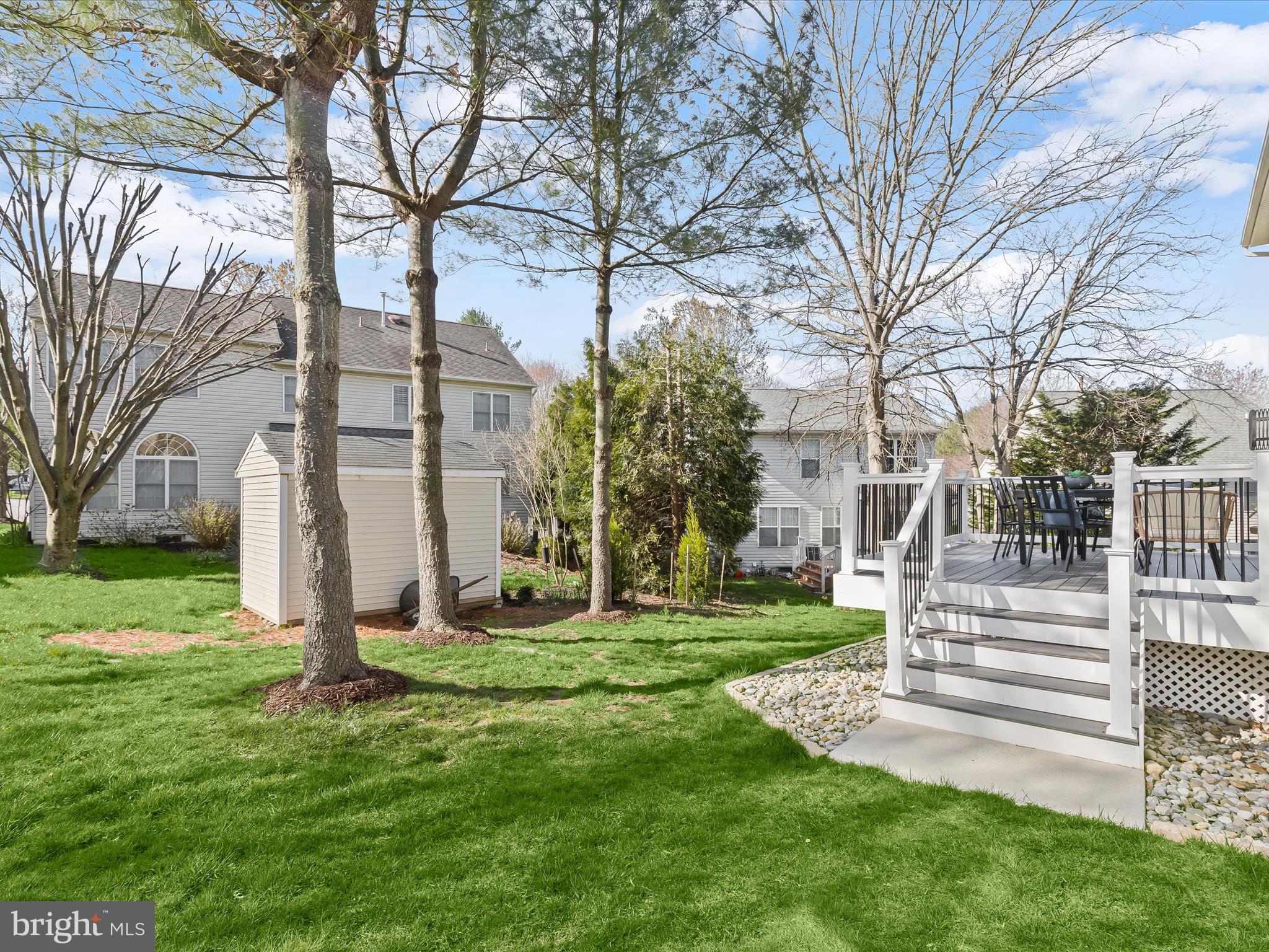 6413 Phantom Moon Walk Clarksville, MD 21029 - Photo 52 of 60 a view of a white house with a big yard and large trees