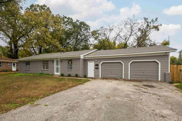 a front view of house with yard and trees