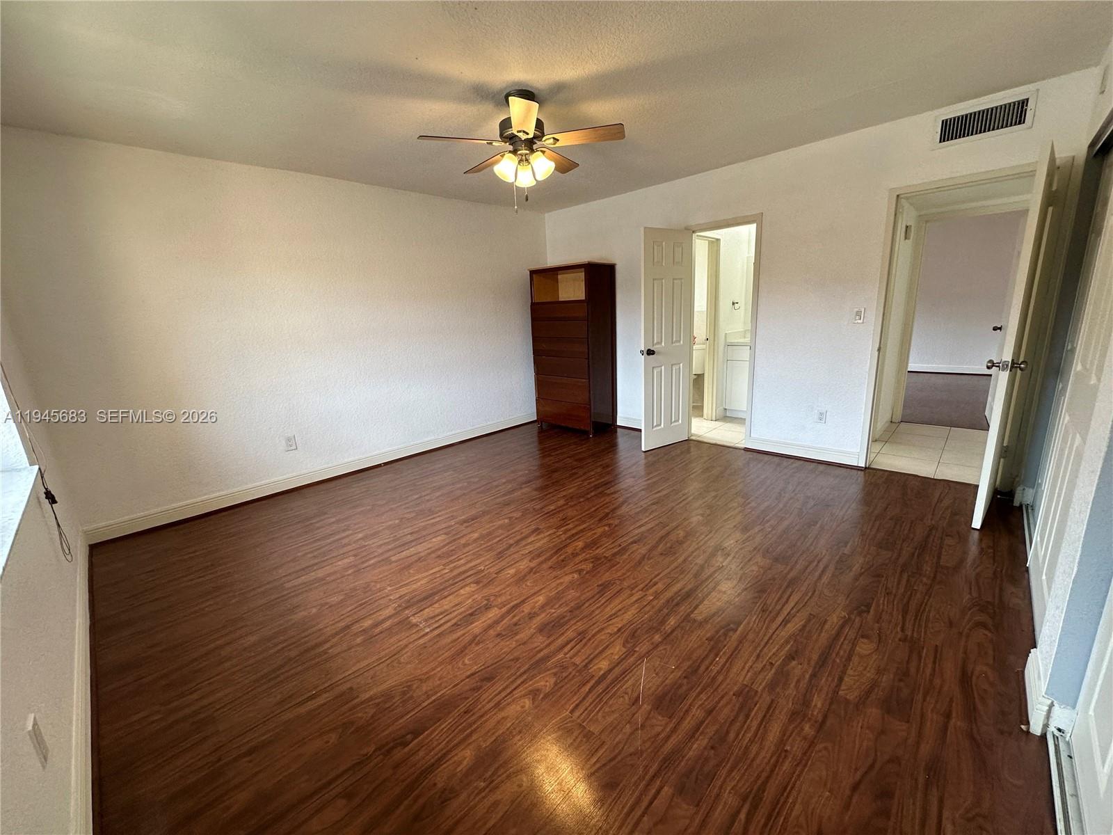 9972 Southwest 88th Street, Unit 1121 Miami, FL 33176 - Photo 5 of 7 wooden floor in an empty room with a window