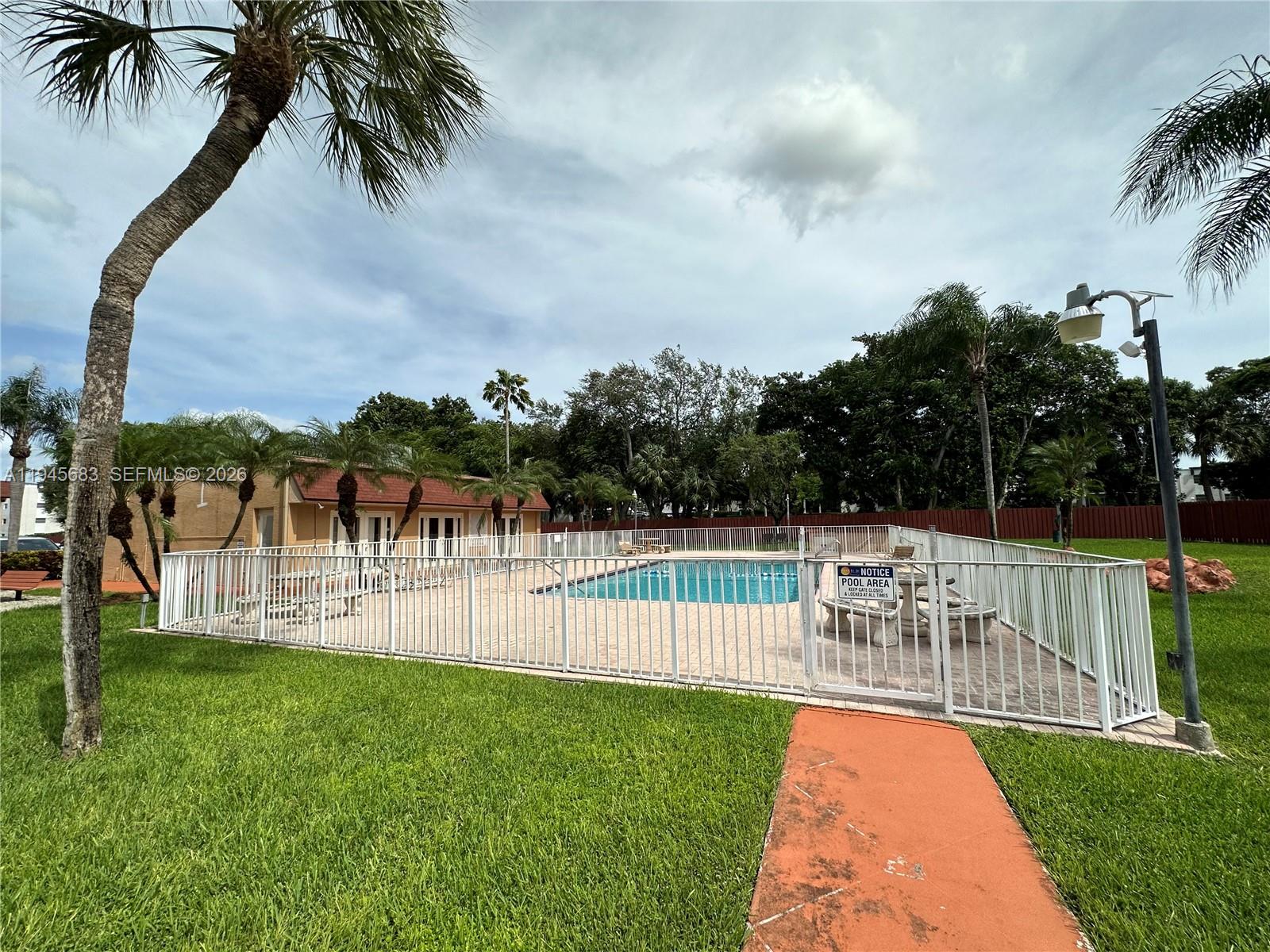 9972 Southwest 88th Street, Unit 1121 Miami, FL 33176 - Photo 6 of 7 a view of a yard with a slide