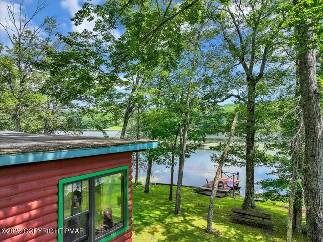 a living room with furniture ceiling fan and a floor to ceiling window
