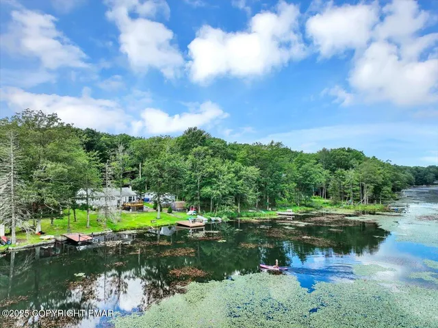 a swimming pool with outdoor seating and yard