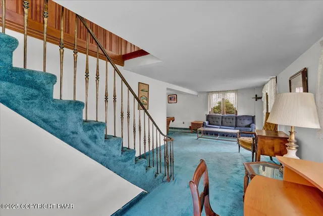 a bedroom with a bed window and dresser