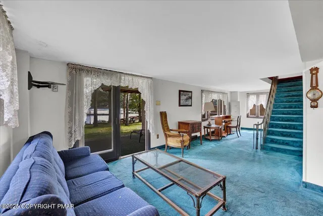 a living room with furniture and a yard