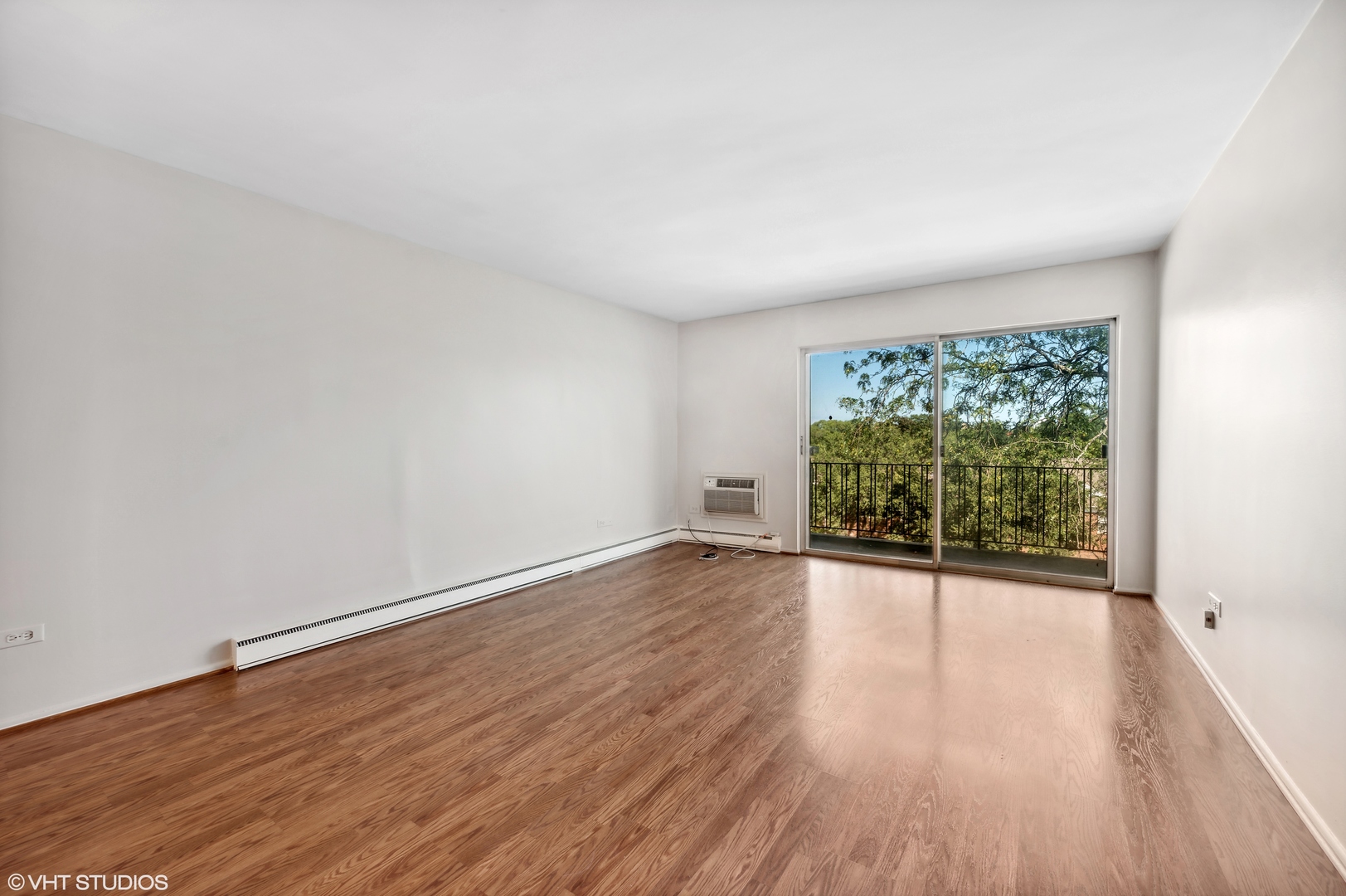 250 Ridge Avenue, Unit 5F Evanston, IL 60202 - Photo 3 of 19 a view of an empty room with wooden floor and a window