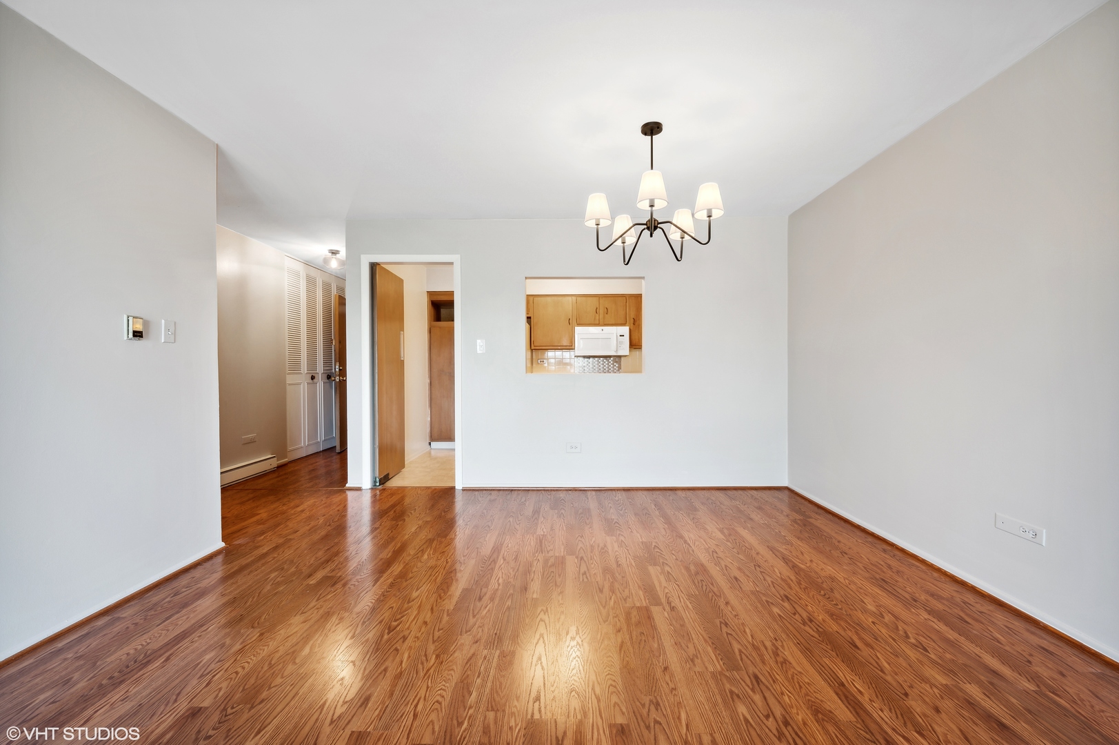 250 Ridge Avenue, Unit 5F Evanston, IL 60202 - Photo 7 of 19 a view of an empty room with wooden floor