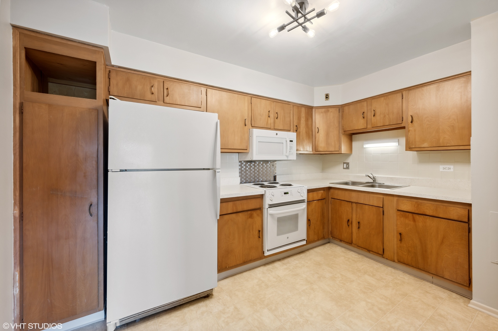 250 Ridge Avenue, Unit 5F Evanston, IL 60202 - Photo 9 of 19 a kitchen with stainless steel appliances granite countertop a refrigerator a sink a stove a microwave and island