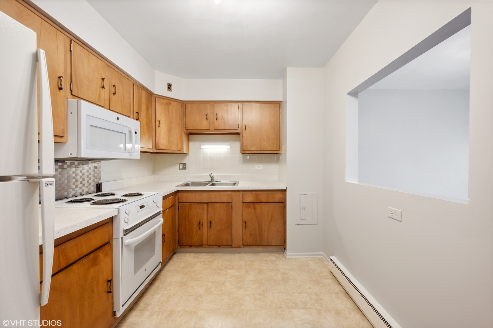 250 Ridge Avenue, Unit 5F Evanston, IL 60202 - Photo 10 of 19 a kitchen with stainless steel appliances granite countertop a stove a sink and a refrigerator