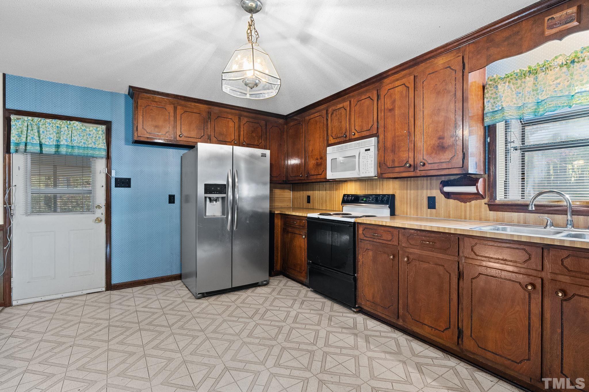 5930 Guess Road Durham, NC 27712 - Photo 11 of 43 a kitchen with stainless steel appliances granite countertop a refrigerator and a sink