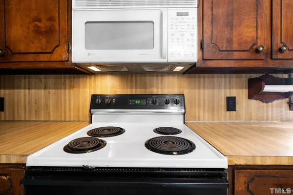 a stove top oven sitting inside of a kitchen