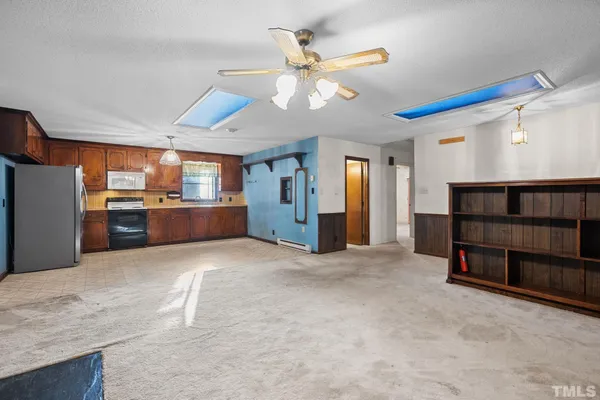 a view of kitchen and refrigerator cabinets