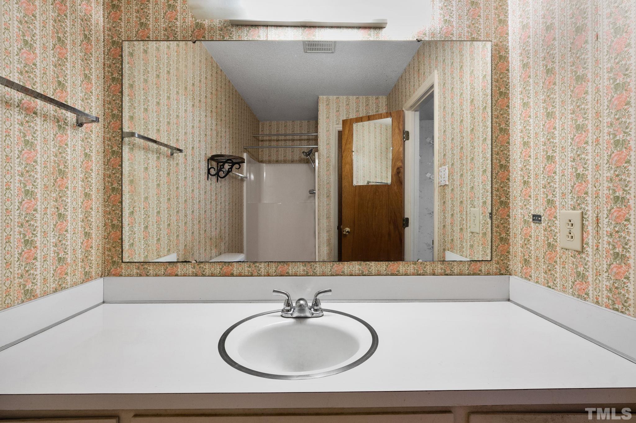 5930 Guess Road Durham, NC 27712 - Photo 20 of 43 a bathroom with a sink and a mirror